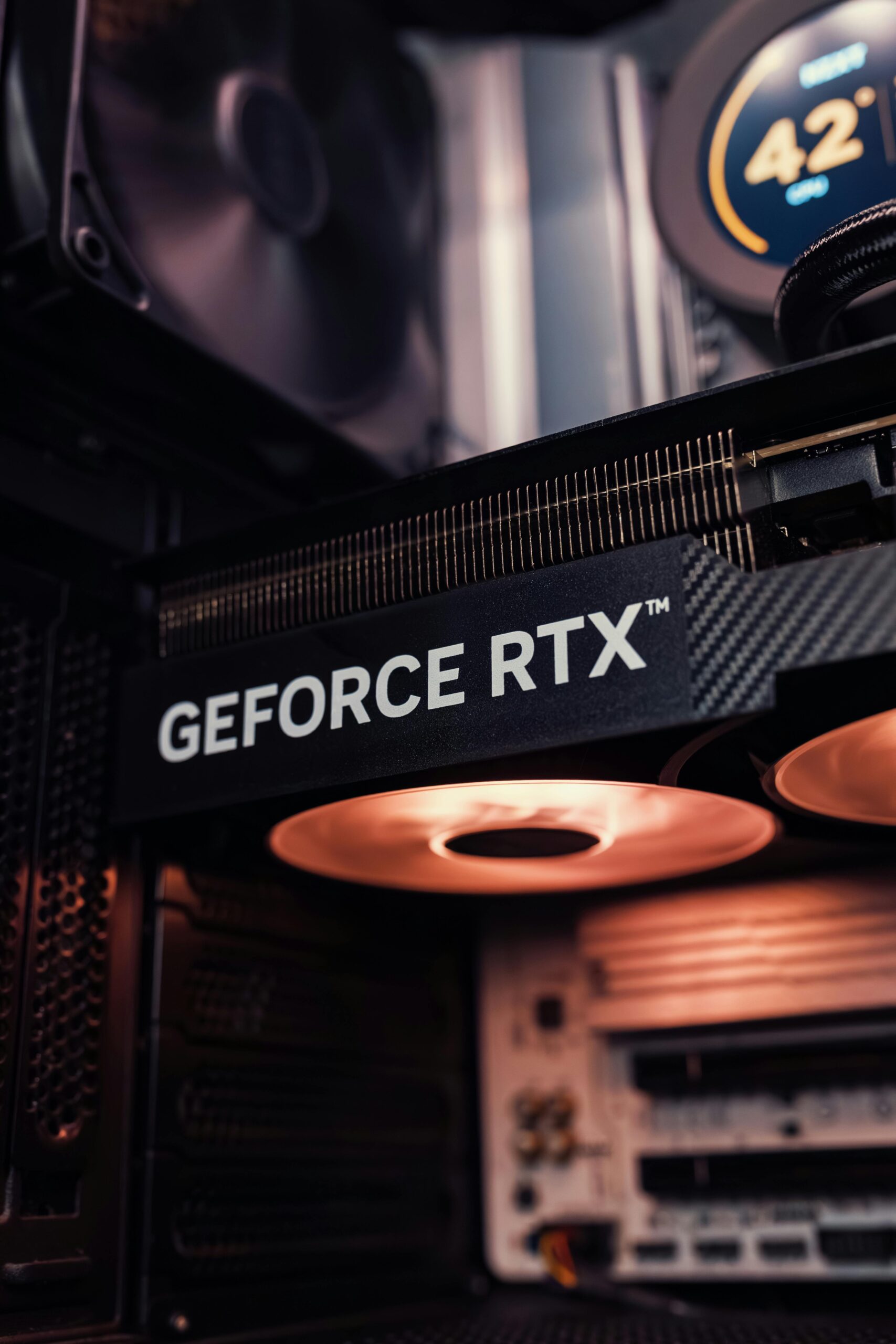 Detailed view of GeForce RTX graphics card inside a computer, showcasing modern technology.